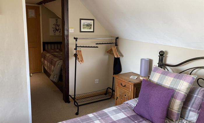 Double room plus a single bed with ensuite shower.  Over looking to the Snowdonia Mountain Range to the side, the small window looks across to the fie